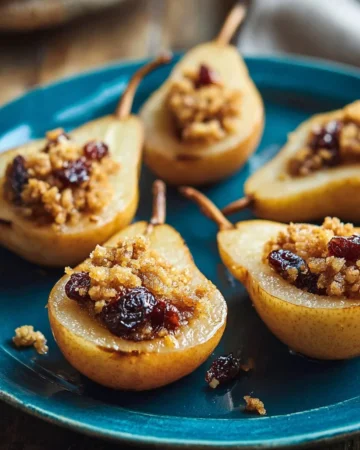 Delicious easy baked pears topped with cinnamon and nuts on a plate