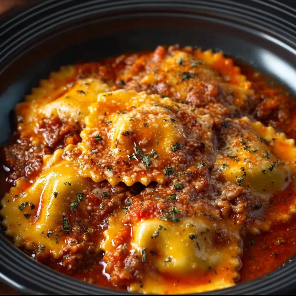 Crockpot ravioli lasagna with layers of cheese, sauce, and ravioli in a slow cooker.
