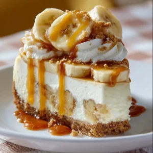 Delicious banana pudding cheesecake topped with whipped cream and banana slices