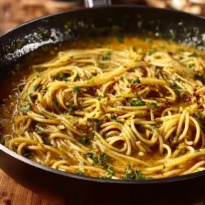 Caramelized onion and garlic spaghetti garnished with fresh herbs