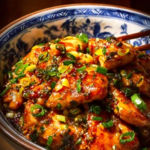 Delicious Chinese scallion chicken dish served with fresh scallions and sauce.
