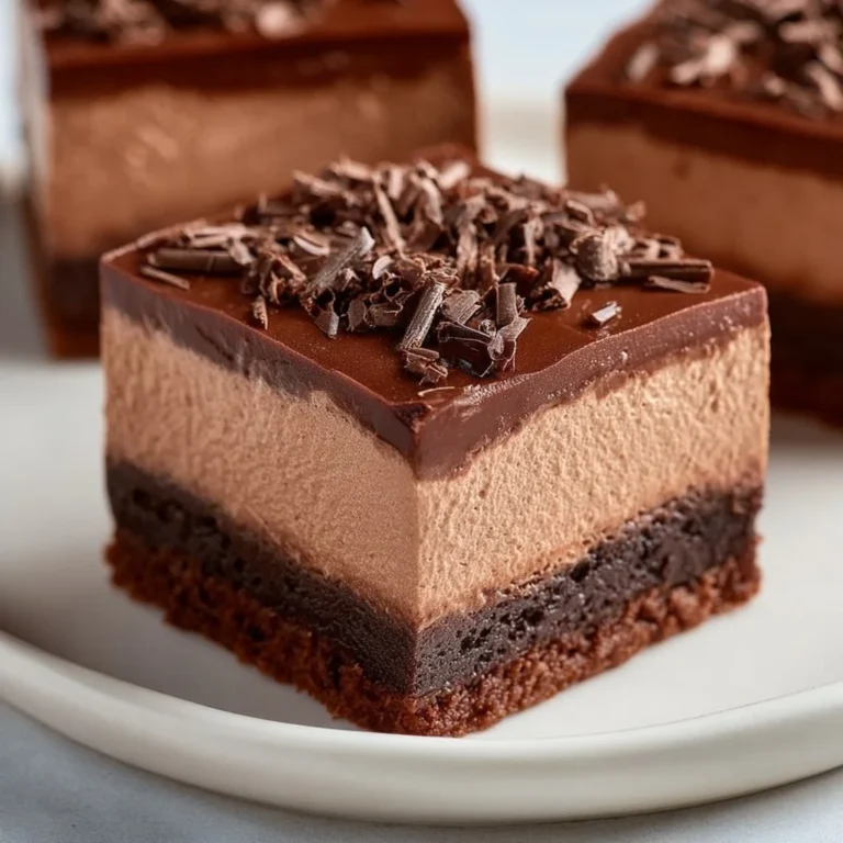 Delicious chocolate mousse brownies served on a plate with a rich chocolate topping.