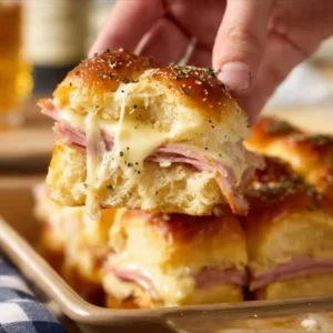 Delicious homemade ham and cheese sliders on a platter ready for serving.