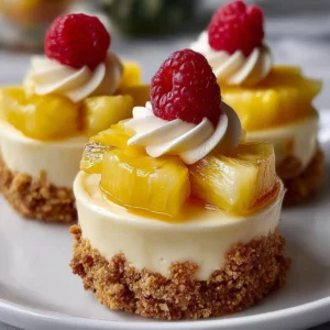 Delicious no-bake pineapple cheesecake dessert topped with fresh pineapple slices.