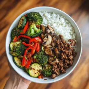 Spicy ground beef stir-fry bowl with garlic veggies and rice