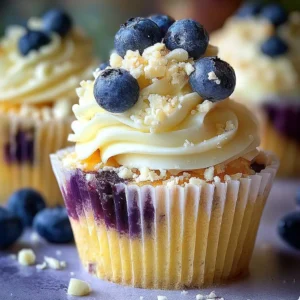 White chocolate blueberry cheesecake cupcakes topped with fresh blueberries