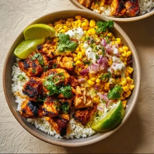 Delicious street corn chicken rice bowl topped with fresh ingredients and flavors.