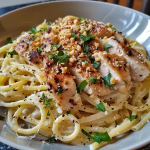 Delicious chicken lemon garlic pasta served in a bowl garnished with fresh parsley.