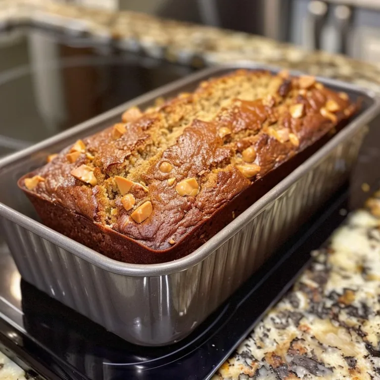 Homemade Peanut Butter Banana Bread loaf with slices on a cutting board