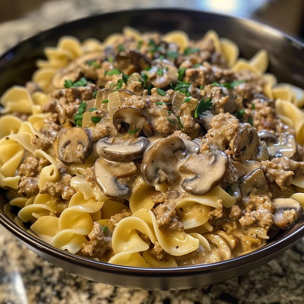 Creamy Ground Beef Stroganoff served with egg noodles and garnished with parsley