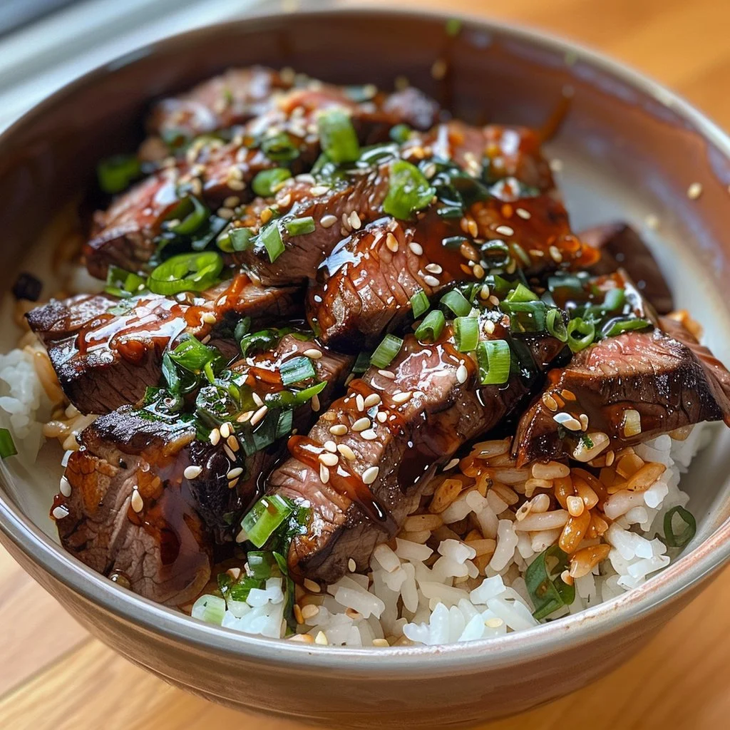 Delicious Teriyaki Steak Rice Bowl garnished with vegetables and sesame seeds