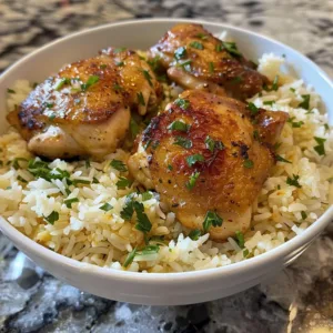 One-pot garlic butter chicken with rice in a skillet